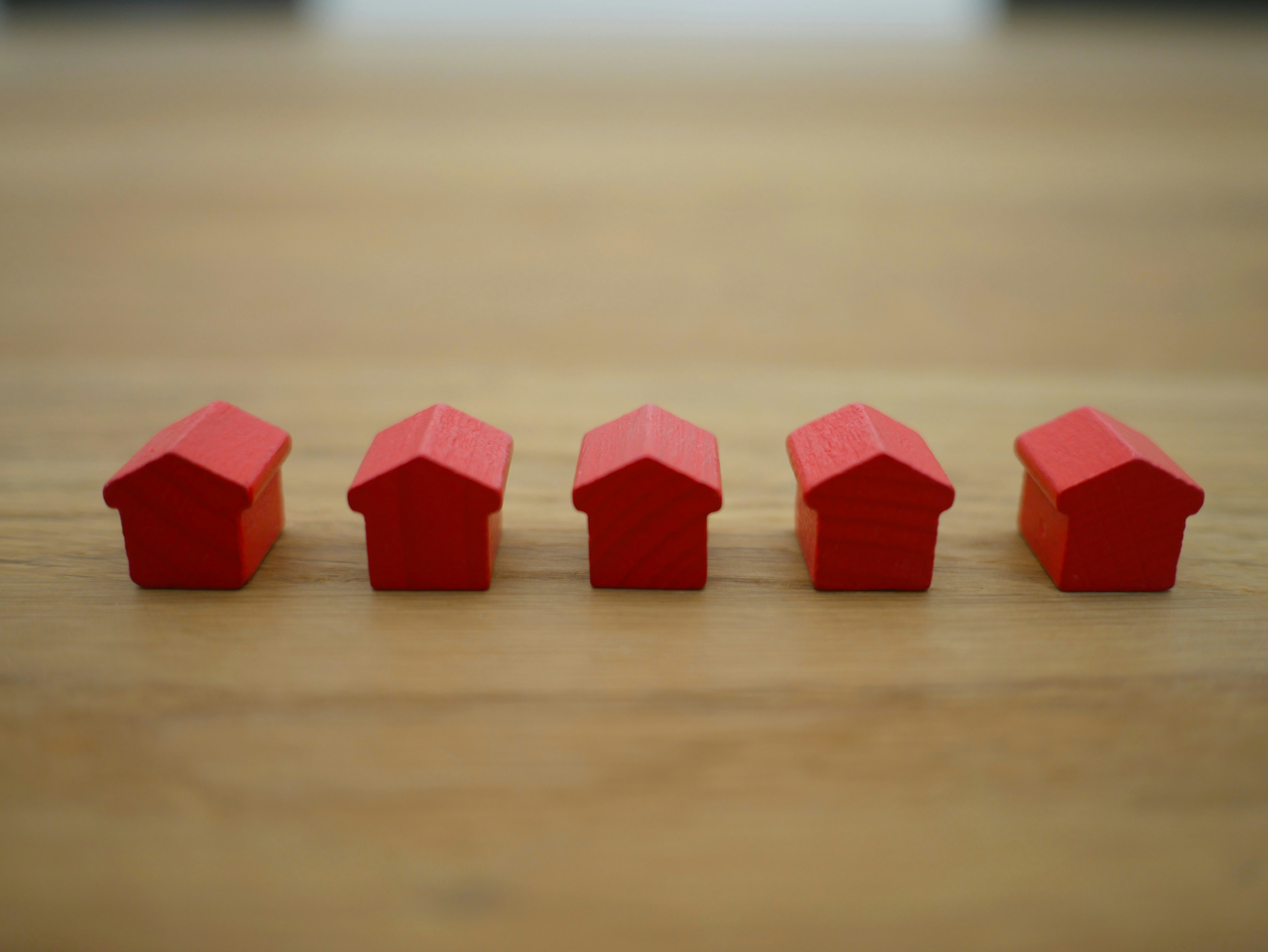 5 red wooden house game pieces